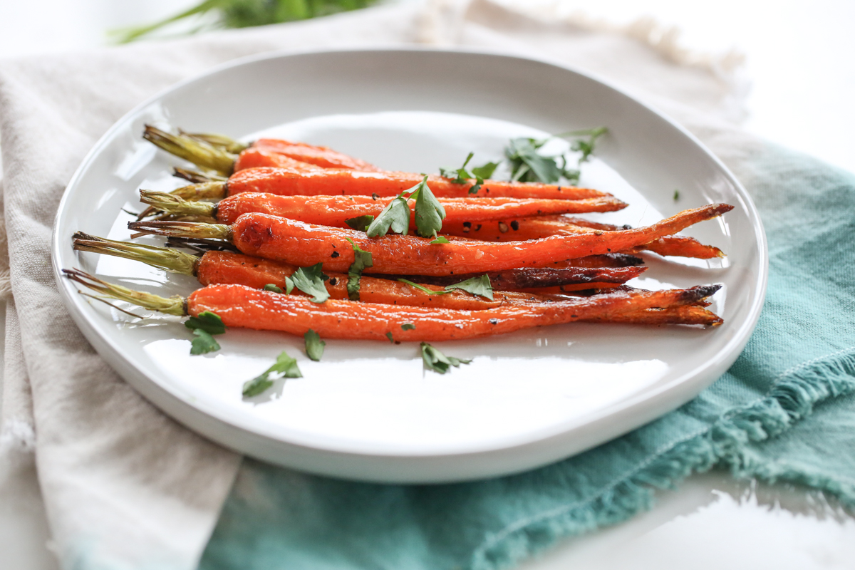 Roasted carrots on a white plate.